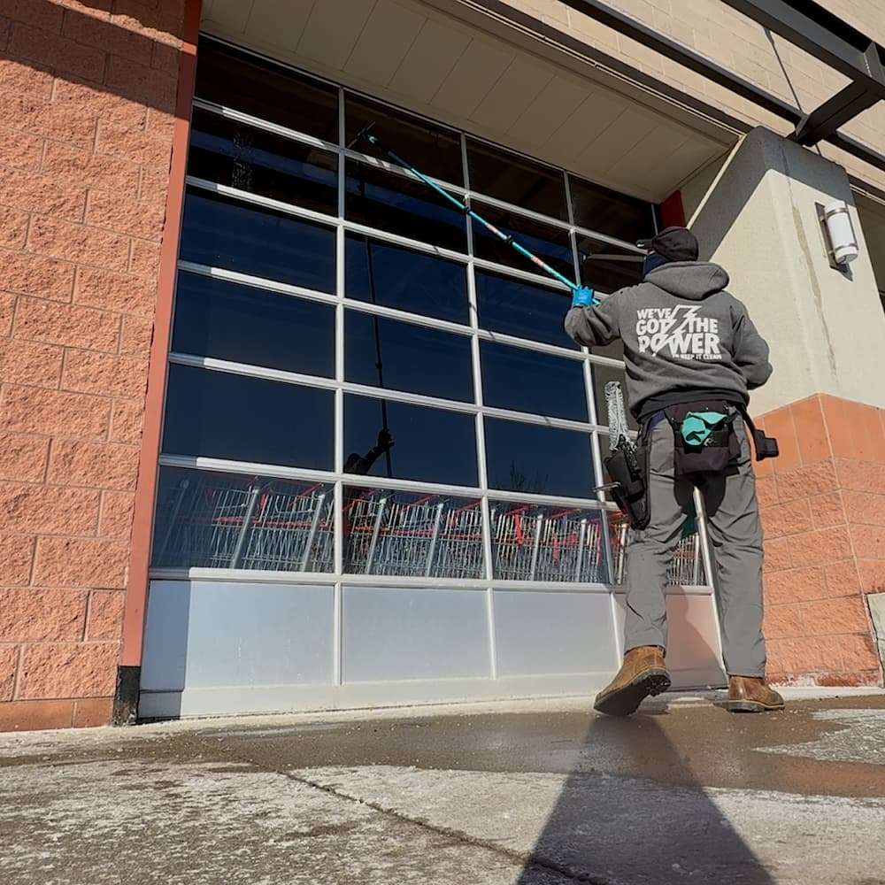 window cleaning the glass entryway of the main offices of the Columbus zoo