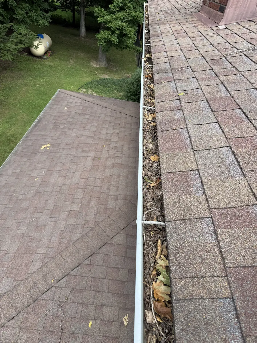 Gutter Cleaning Before 2 Leaves and debris completely clogging gutters before being cleaned by power clean