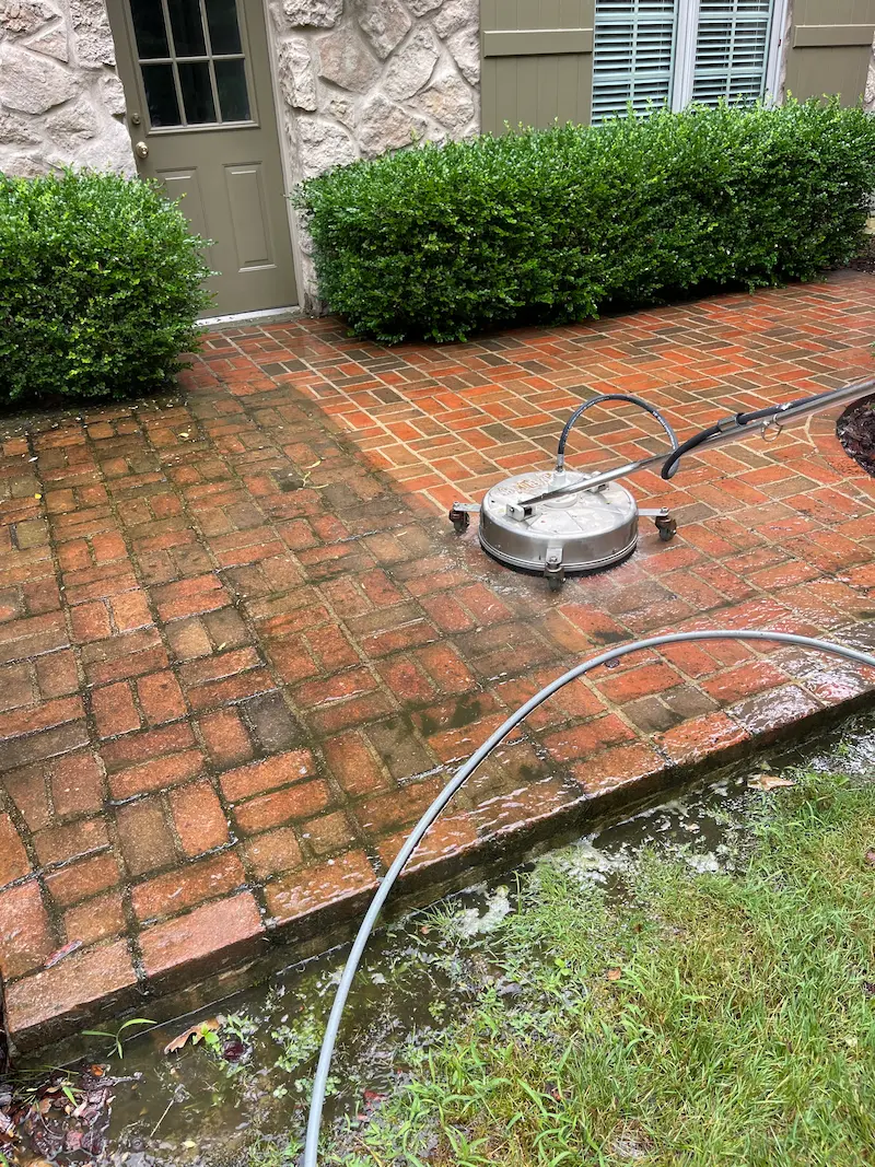 Pressure washing brick pavers by power clean technician