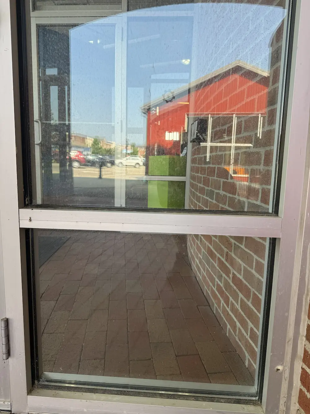 dirty window before being professionally cleaned by power clean technician