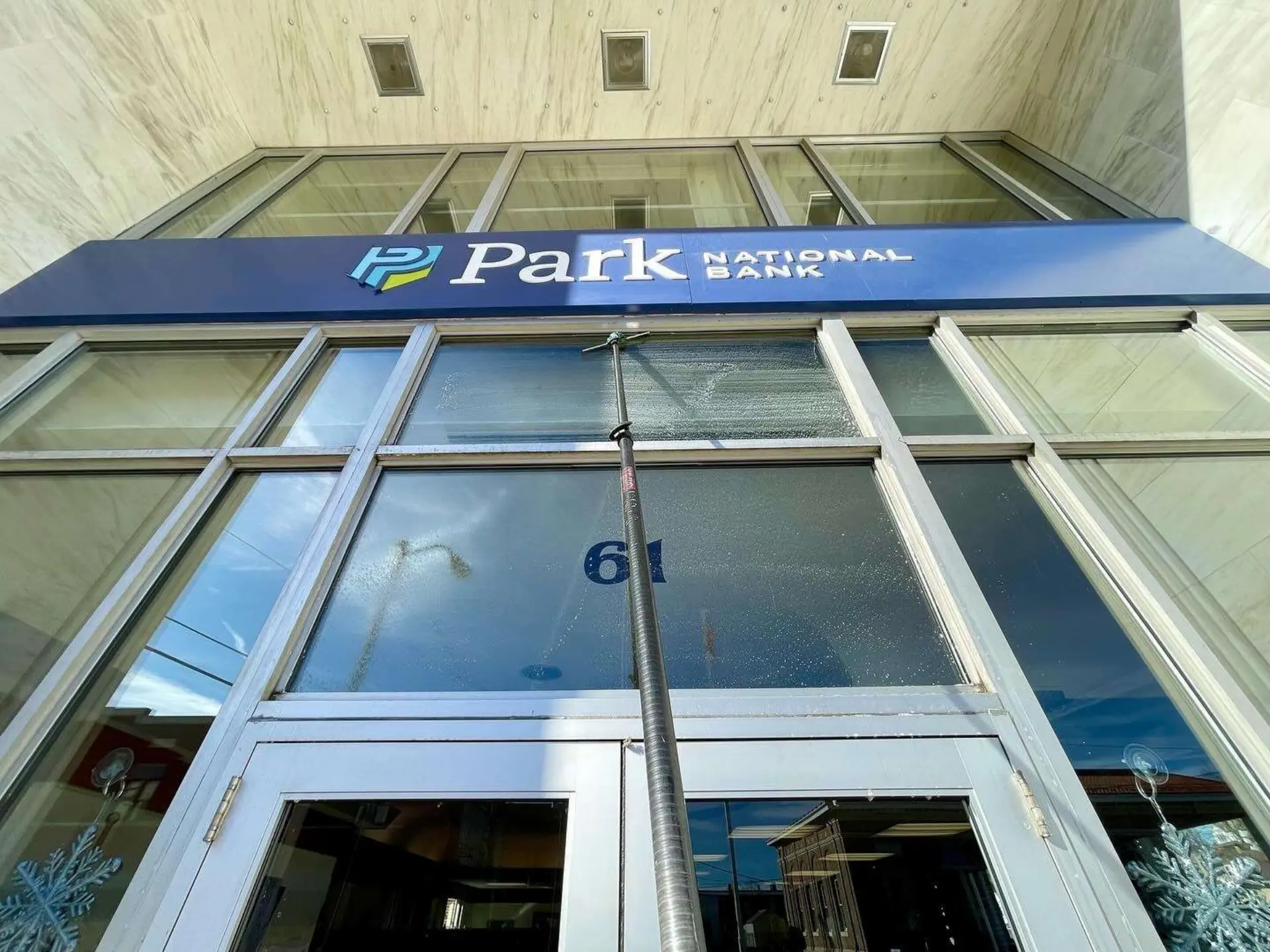 Park National Bank upper windows being cleaned by Power Clean