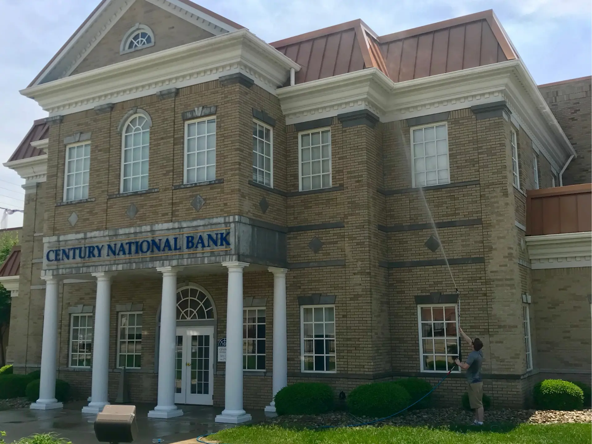 century-national-pressure-washing century national bank being pressure washed by power clean technician
