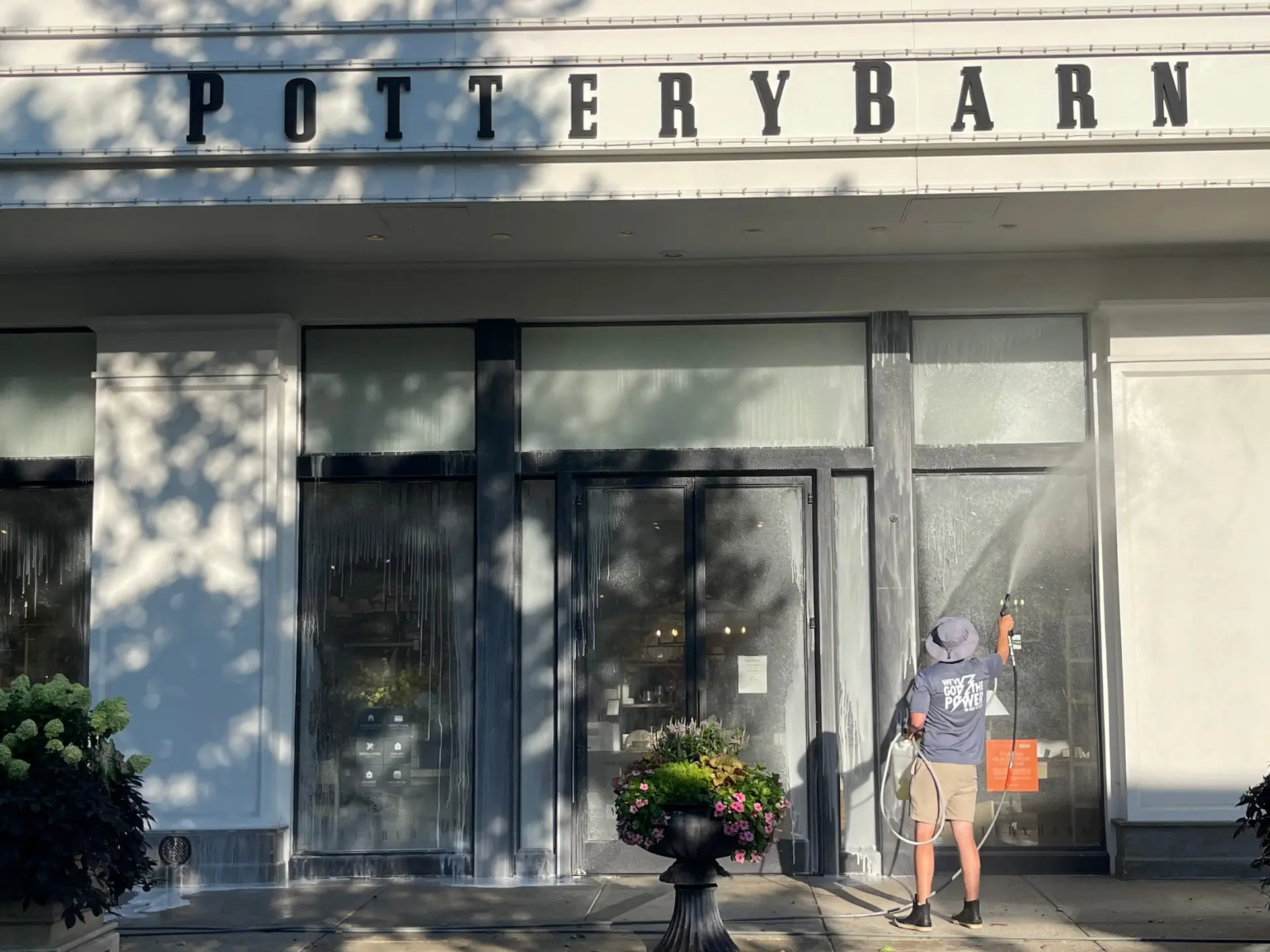 power clean technician pressure washing the entry way of pottery barn at easton in Columbus, oh