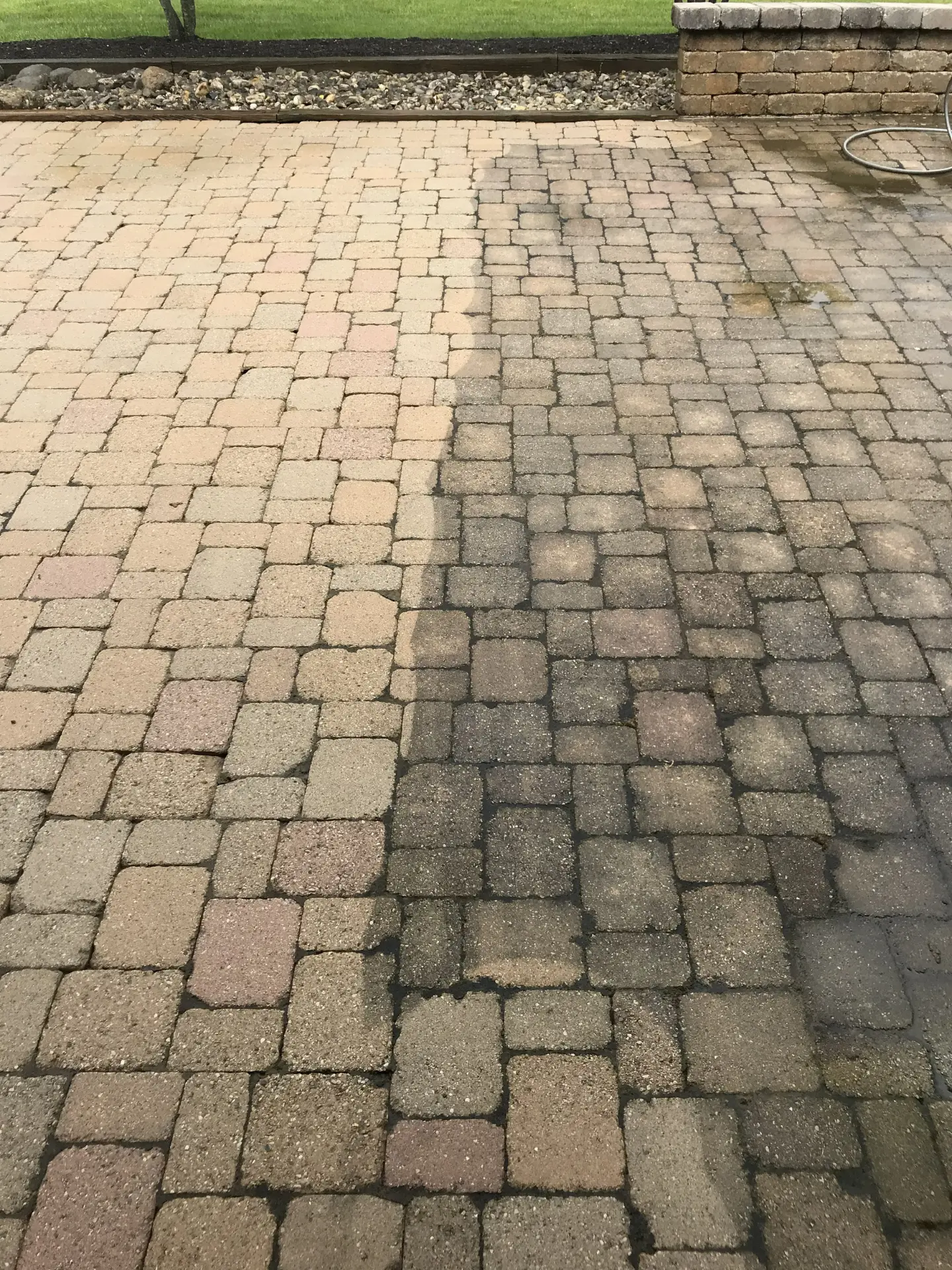 dirty-stone-paver-before-after before and after of stone pavers in the process of being pressure washed