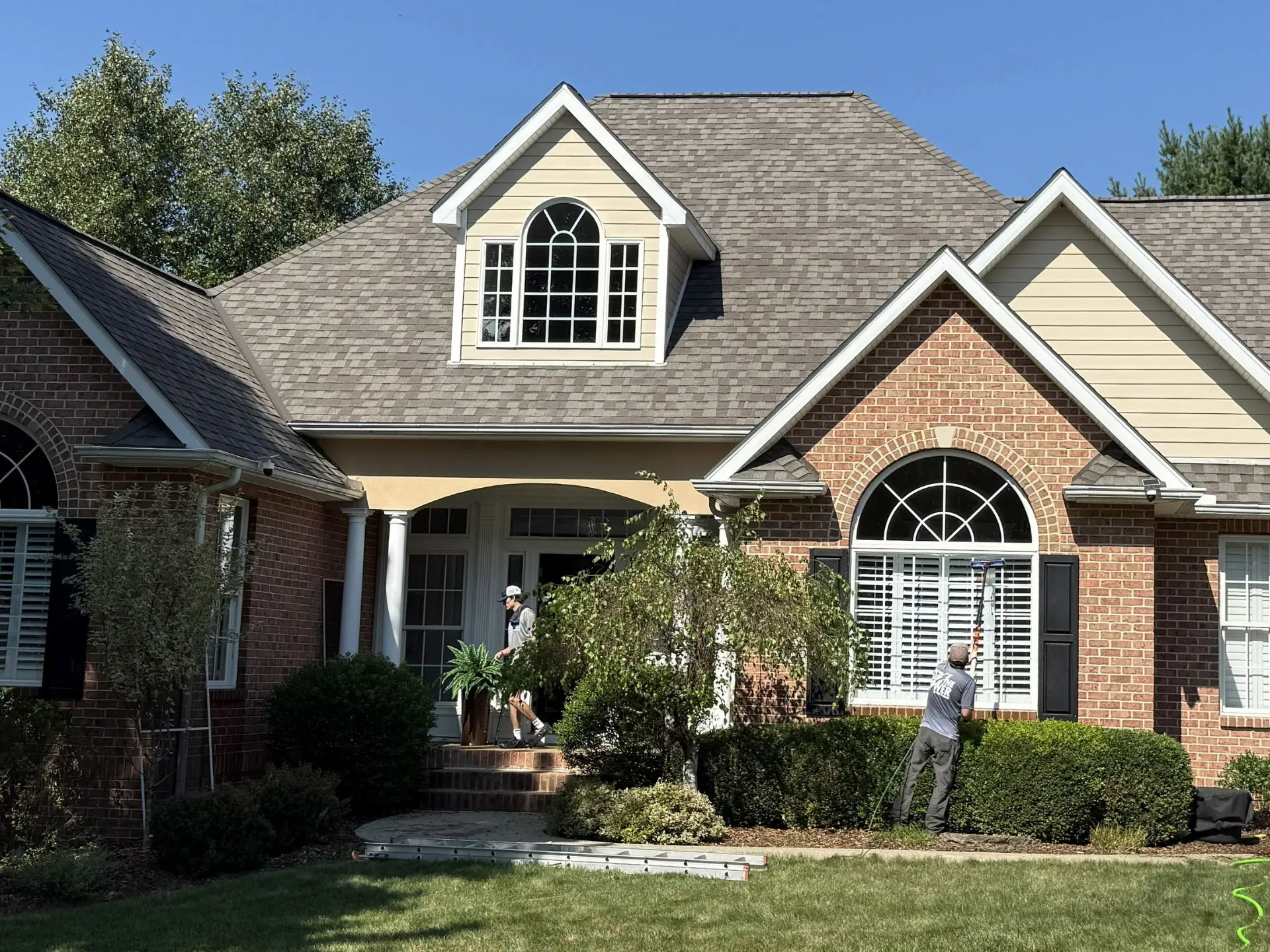 front-window-cleaning.webp power clean technician cleaning the front exterior windows of a house
