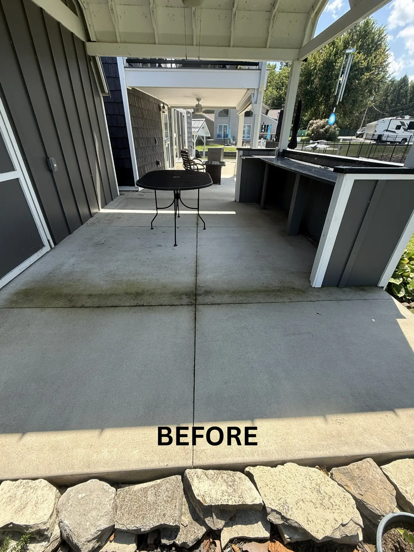 concrete back patio in heron bay thornville before being pressure washed