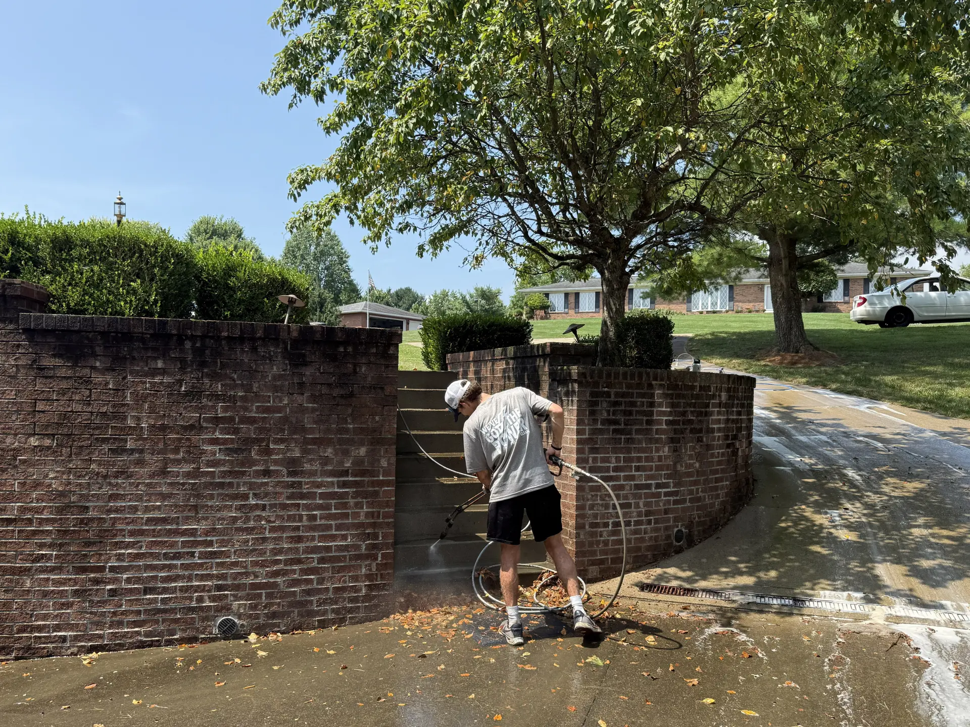power clean technician pressure washing the brick retaining walll of a home in Lancaster OH