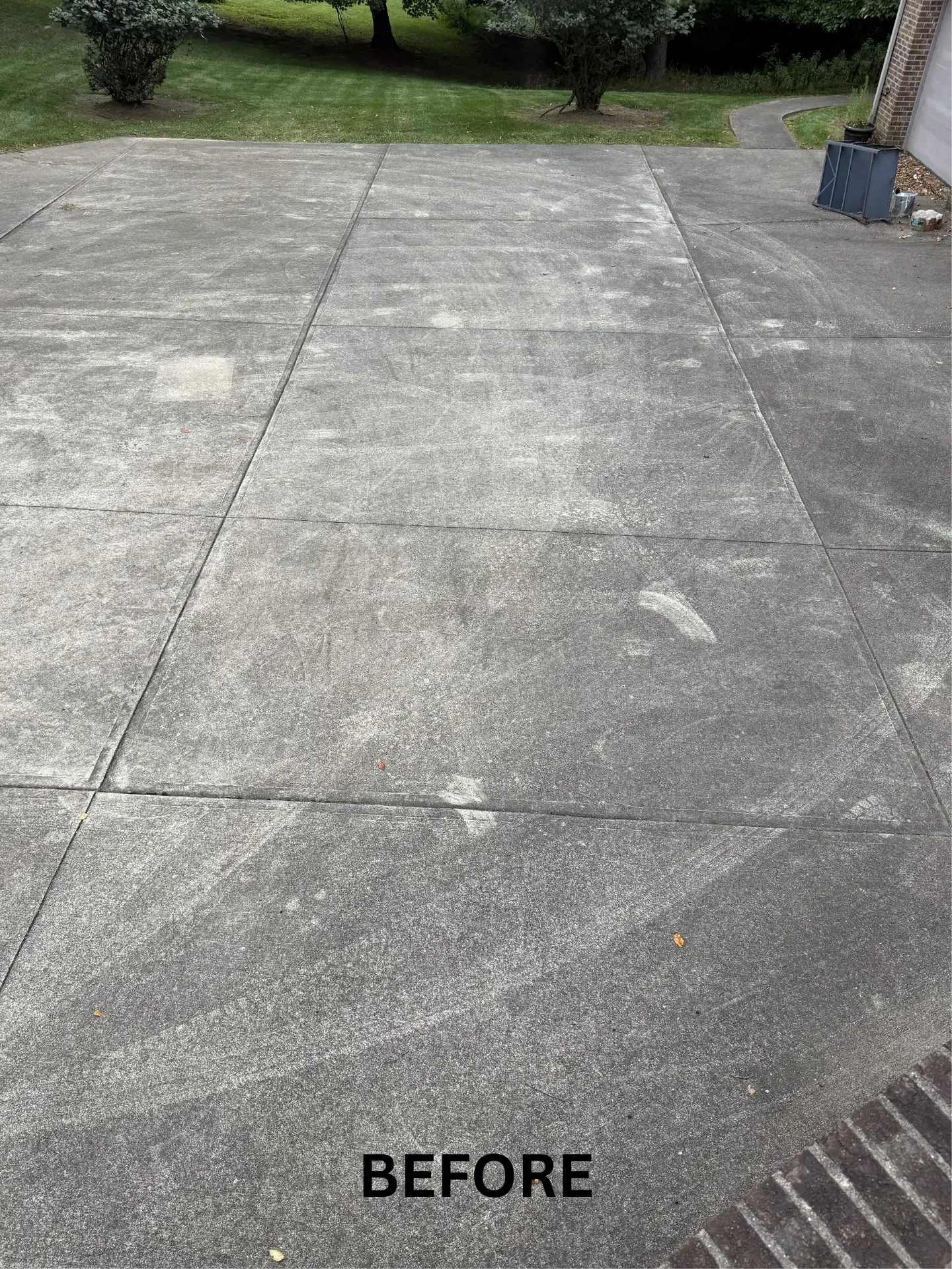 Residential concrete driveway in lancaster before being pressure washed