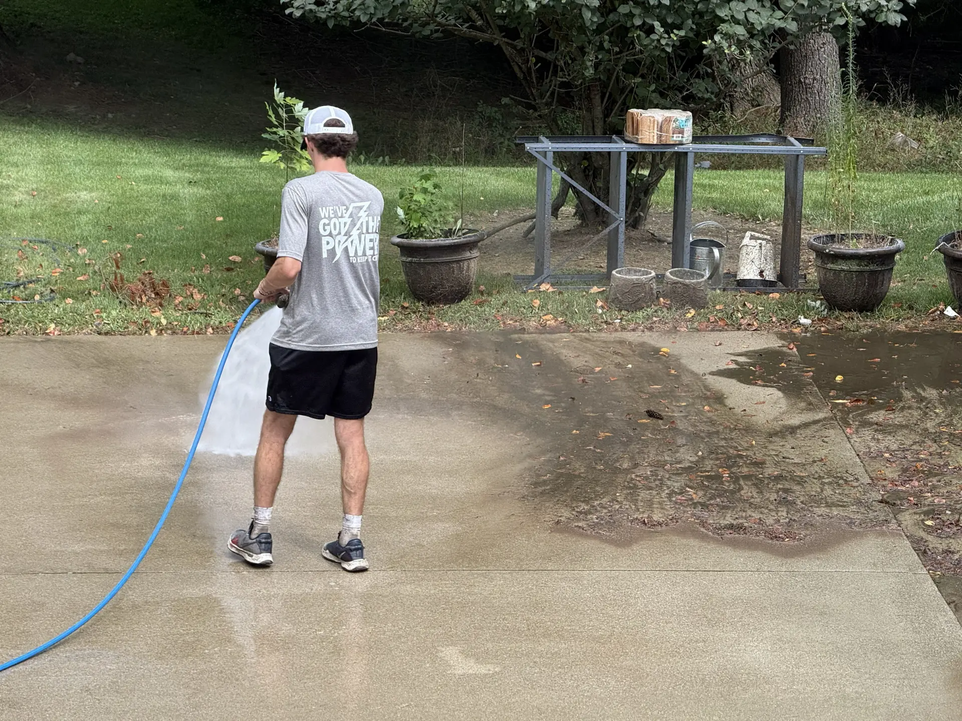 Power Clean technician power washing a concrete pad at a home in Lancaster, oh