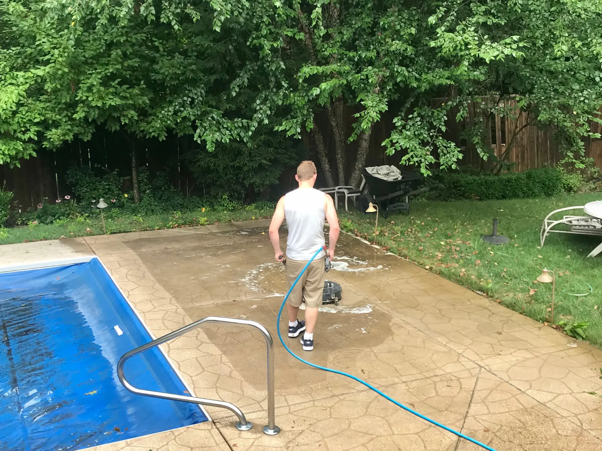 Power Clean technician pressure washing a concrete pool surround in Zanesville OH