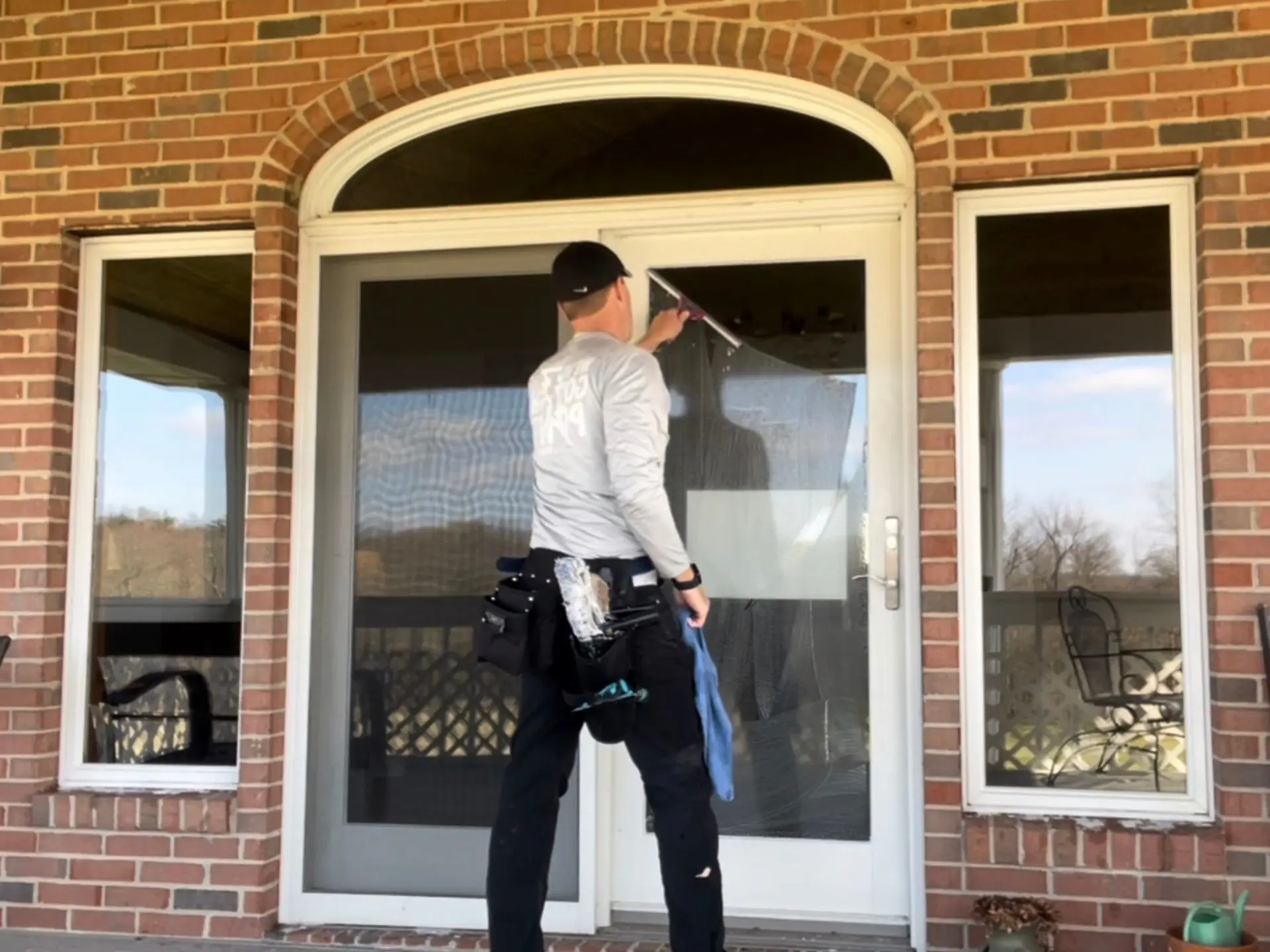 residential-professional-window-cleaning.webp Power clean technician cleaning the entry of a home