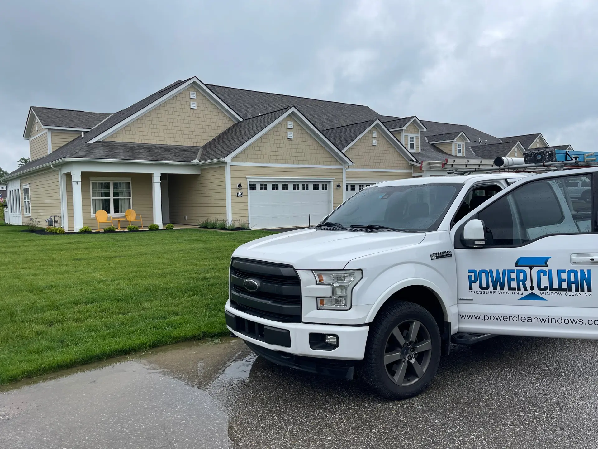 Picture of a white Power Clean truck as technicians are cleaning windows around Buckeye Lake
