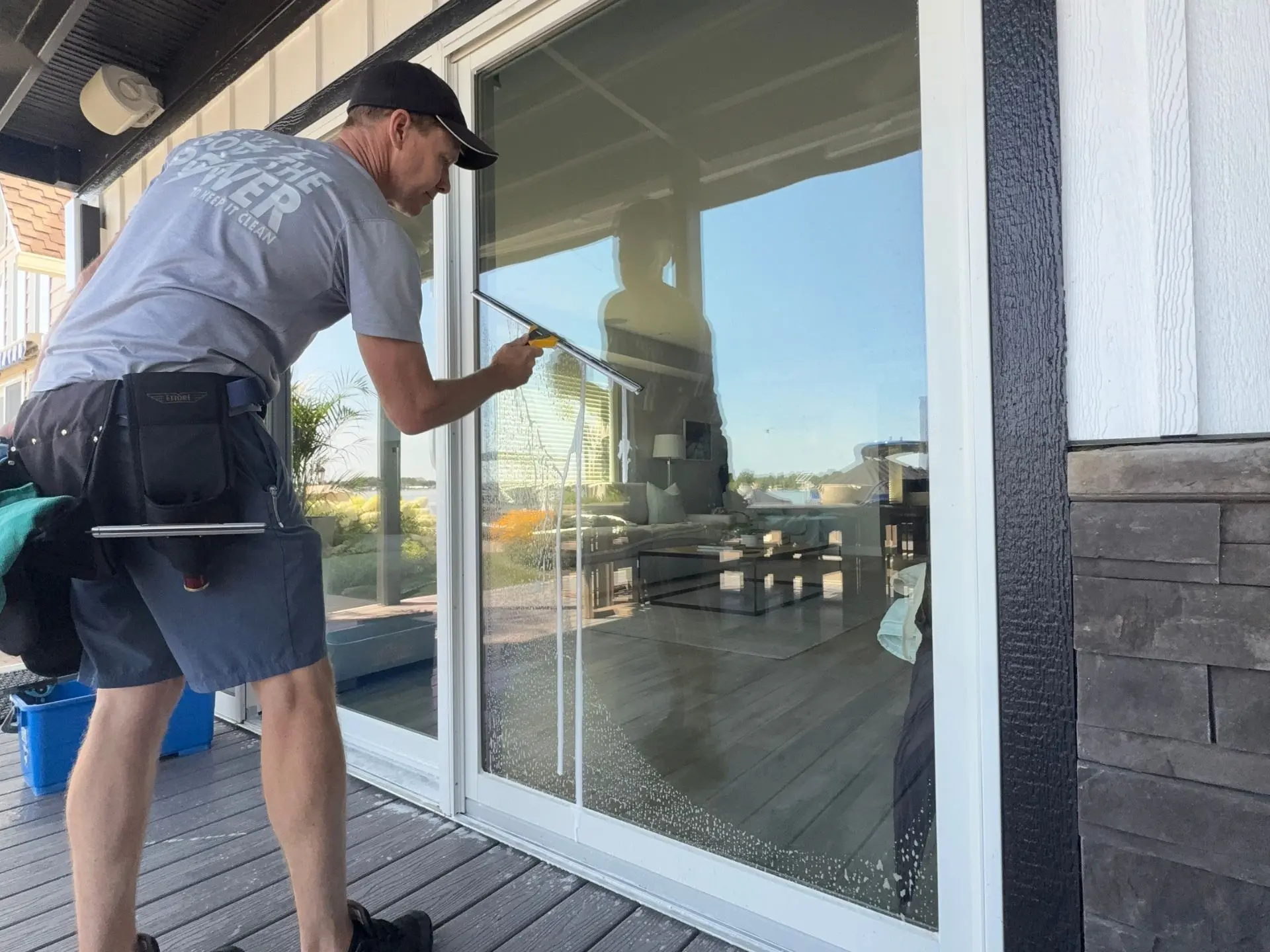sliding-glass-door-cleaning.webp Power clean technician cleaning the glass sliding doors of a home in Buckeye Lake Oh