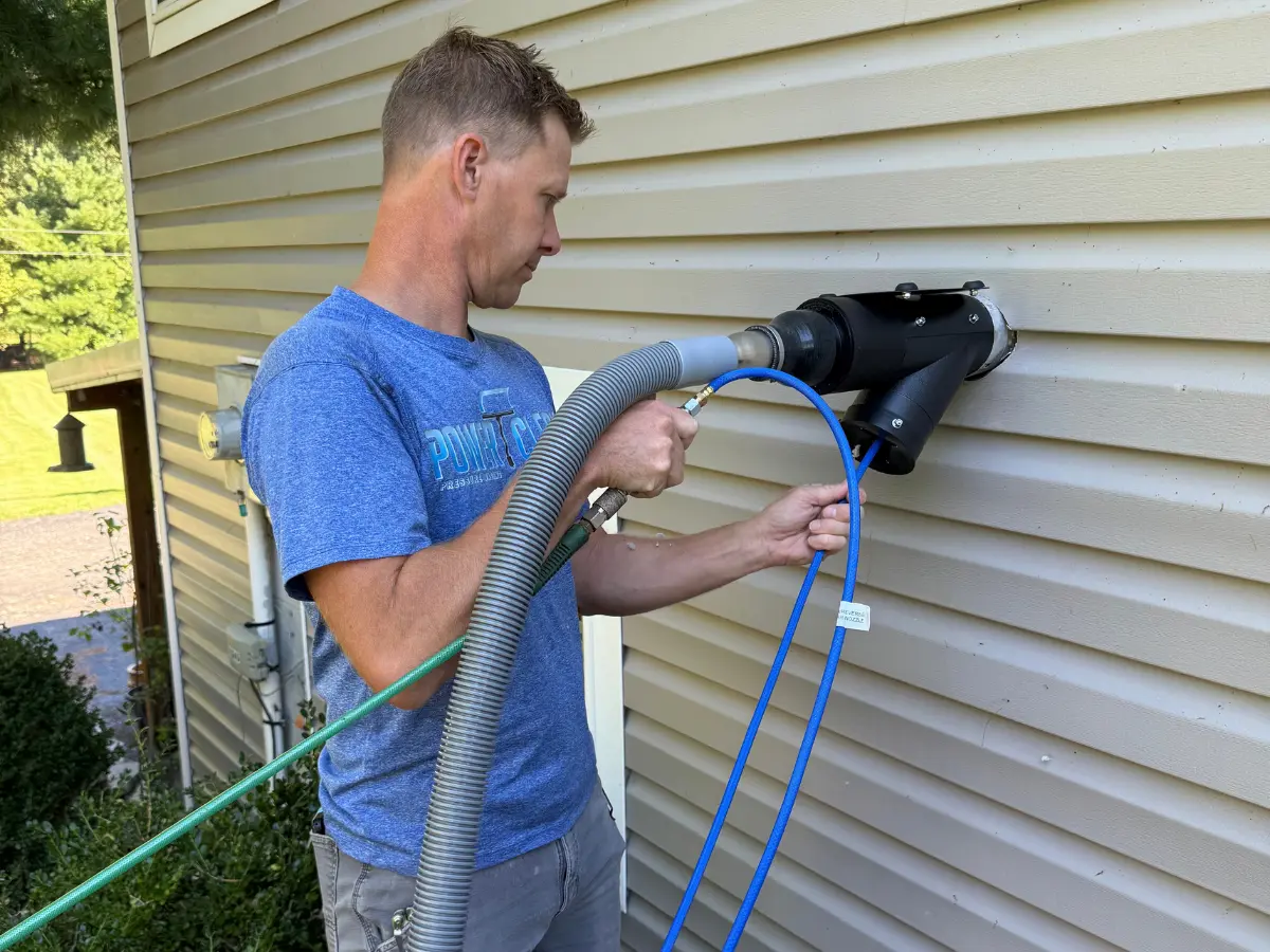 Your paragraph text (1200 x 225 px) (1200 x 900 px) (2) Power Clean technician holding dryer vent cleaning equipment and in the process of cleaning a dryer vent at a home in Thornville, OH
