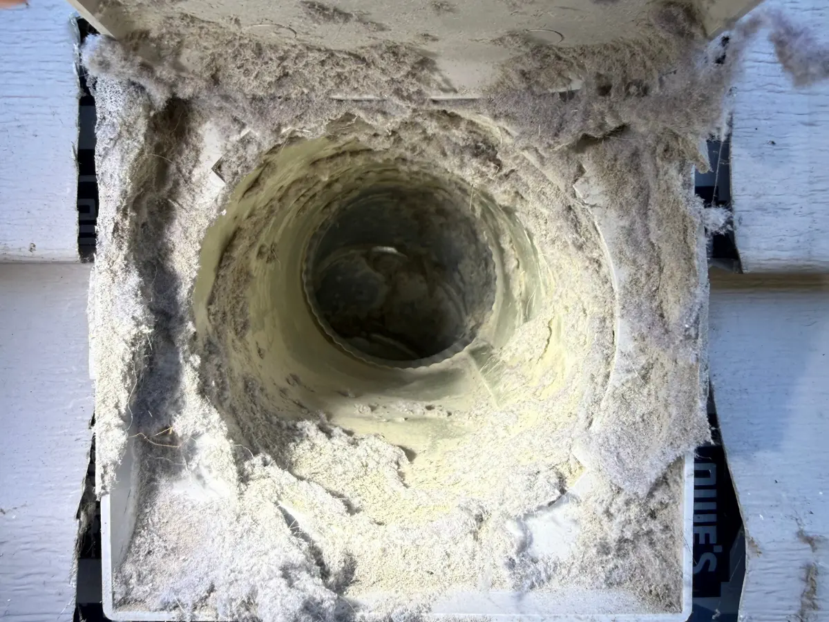 Your paragraph text (1200 x 225 px) (1200 x 900 px) Dryer vent with lots of lint inside and covering the outside before being professionally cleaned